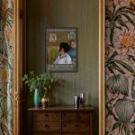 the-antagonist-reklame-plakat-solo-udstilling-paa-groen-vaeg-over-brun-kommode